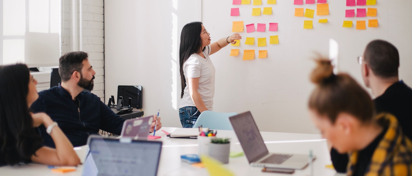 Strategy and delivery team collaborating at a bright modern workspace